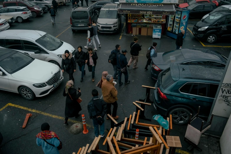 a group of people standing around outside by a building