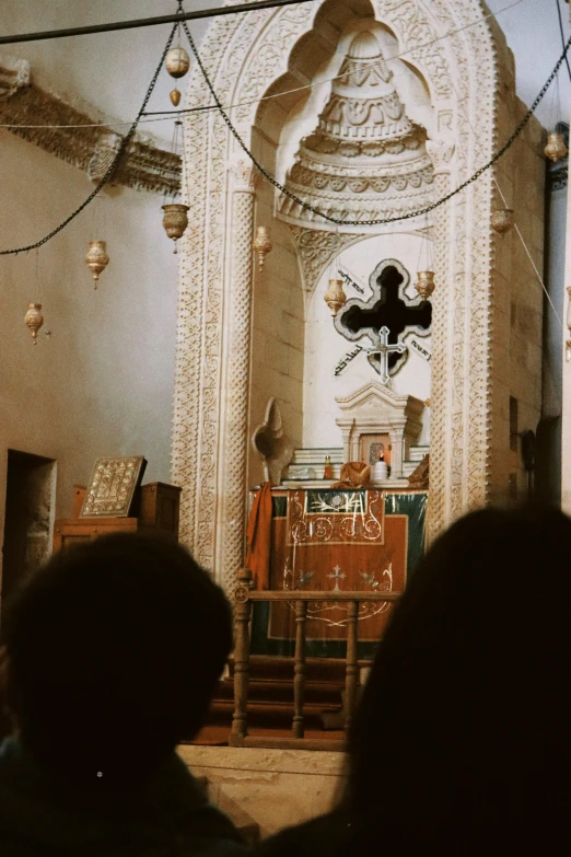 a church with a clock, cross, alter, and other objects on display