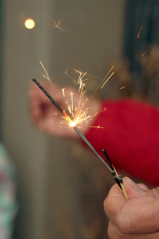 a person holding a sparkler in their hand