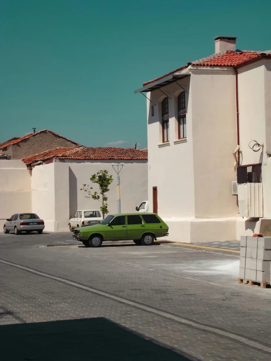 two vehicles parked outside a church in the daytime