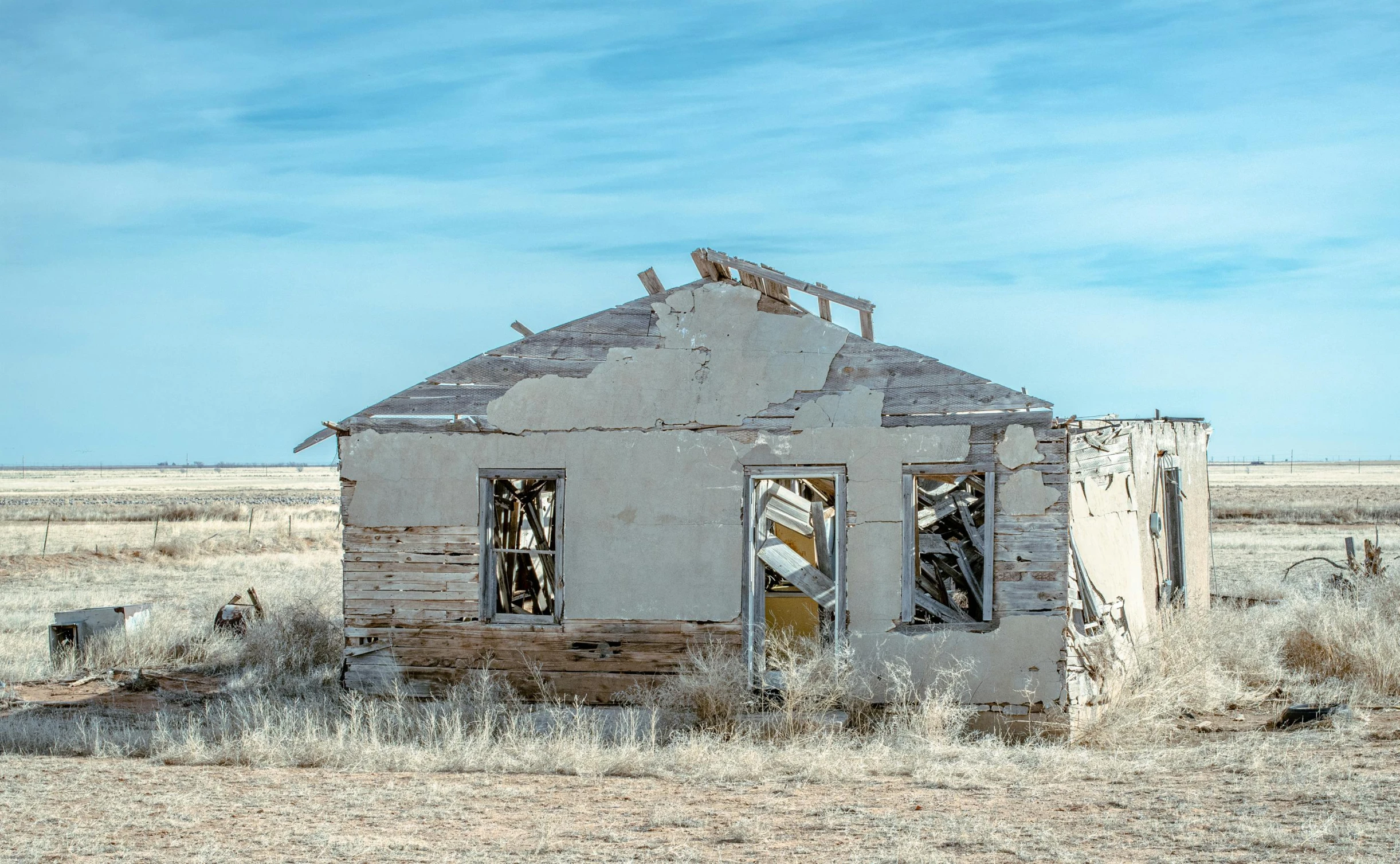 an old run down building in a field