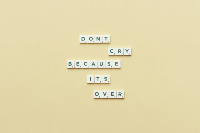 small word tiles that spell out don't cry because its over