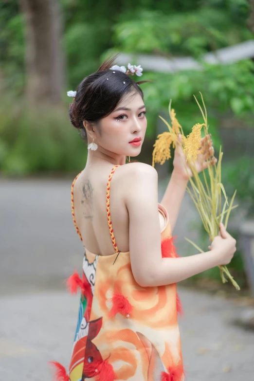 a woman with flower hair clips holding yellow flowers