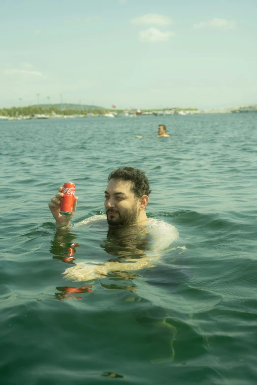 a man in the water holding a frisbee