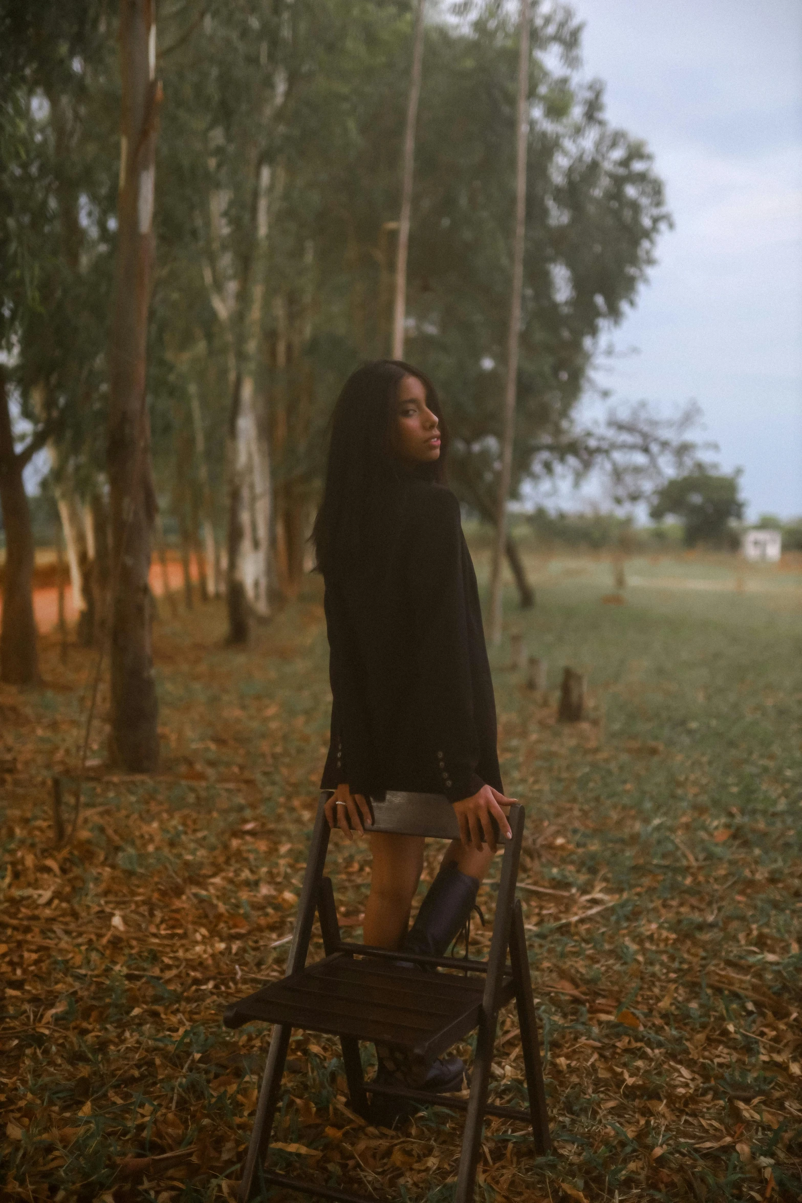 a woman sitting on top of a folding chair