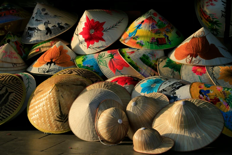 a market with a pile of straw hats and a large pile of coconuts