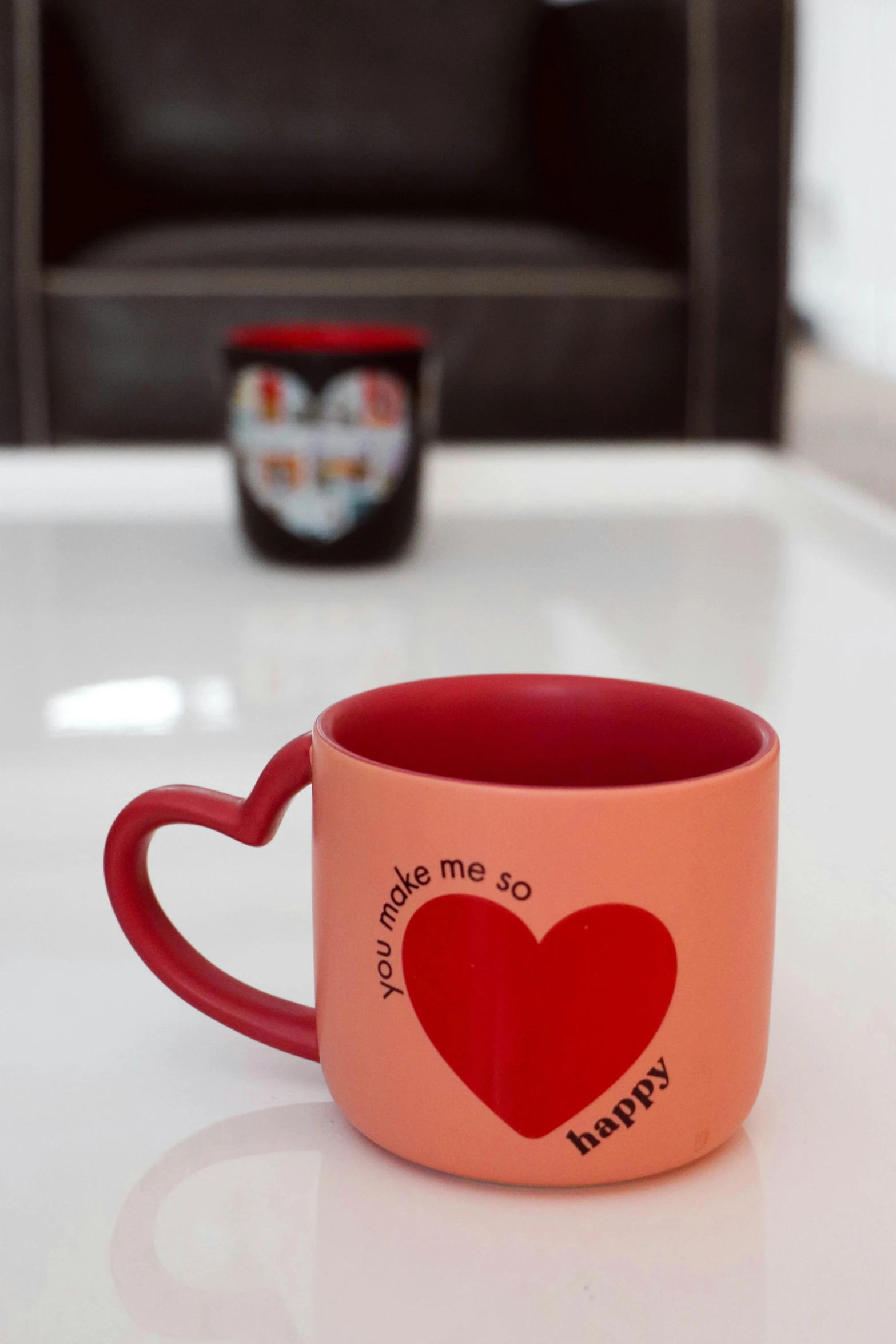 two heart mugs are sitting on a white table