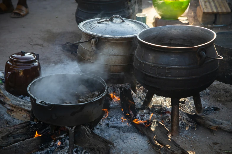 pots are cooking and boiling on the fire