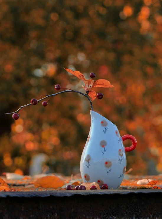 a vase holding berries is standing out of the grass