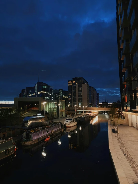 the buildings and boats are illuminated at night