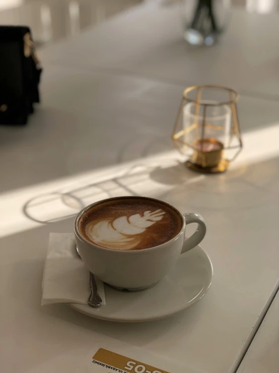 cup with a liquid in it on white plate