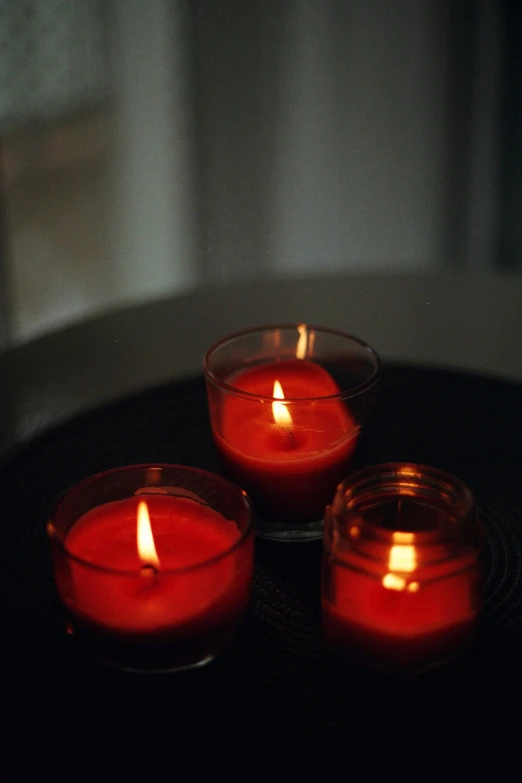 three candles set on top of a round surface