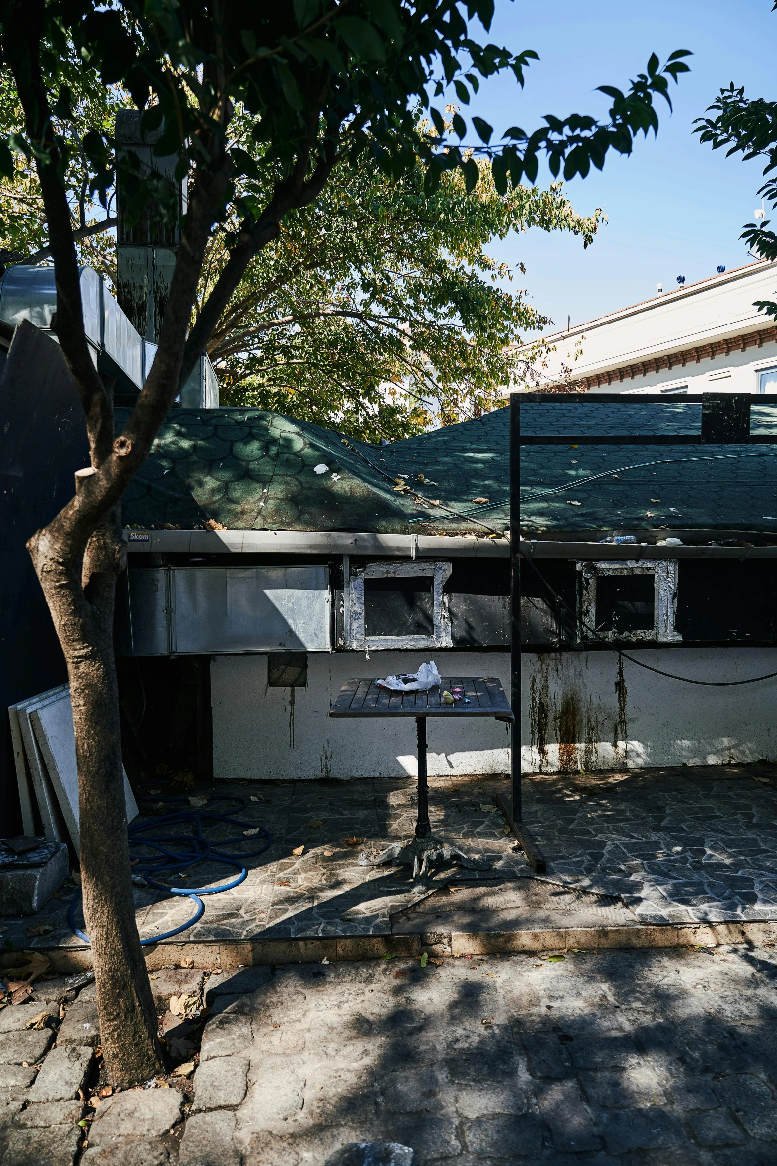 a street view of some broken down houses and a tree