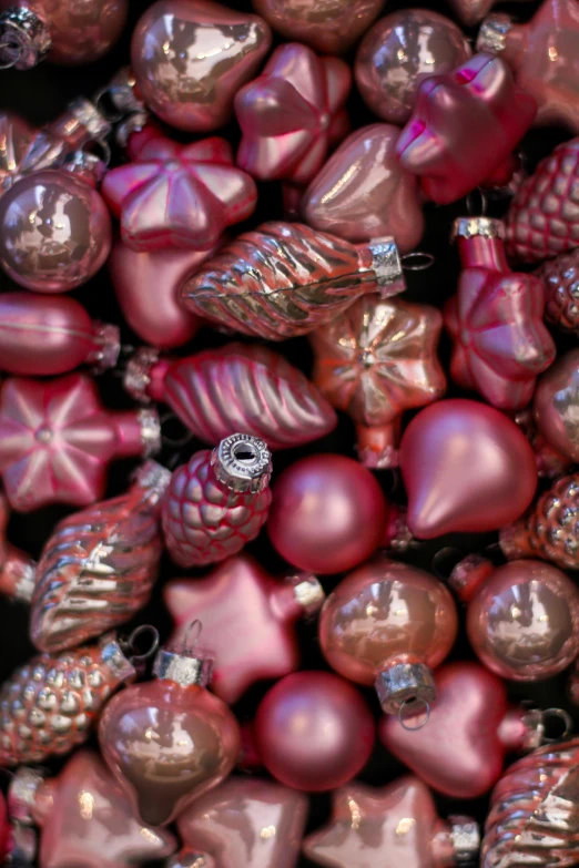 an assortment of pink ornaments displayed on a table