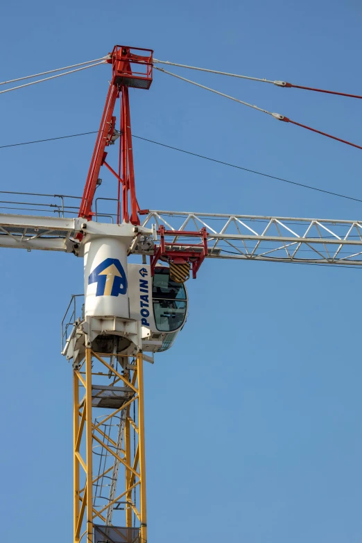 a large crane and a water can are on a pole