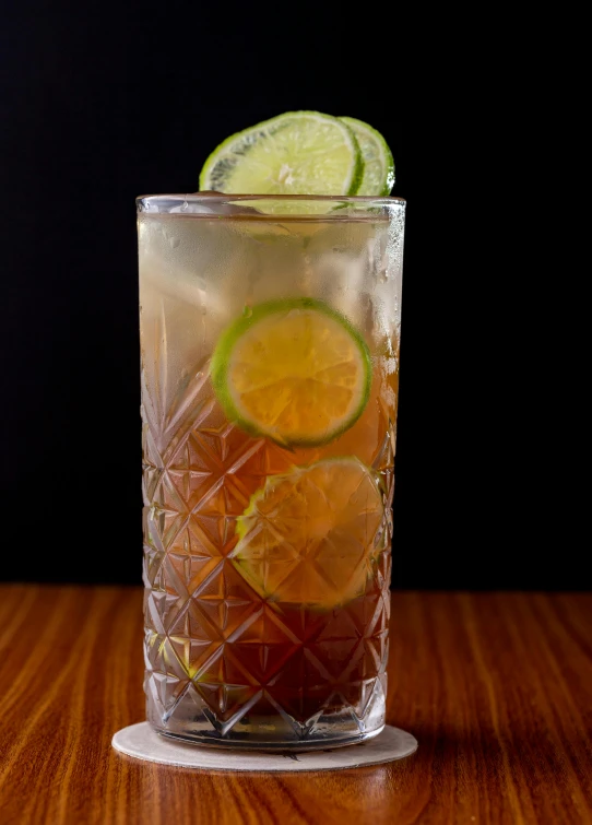 an orange slice sits on the edge of a drink