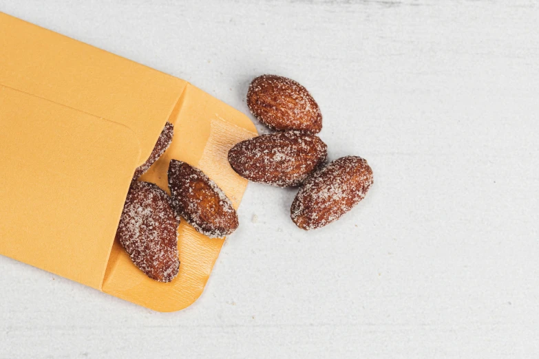 a plate with chocolate donuts on it and orange paper