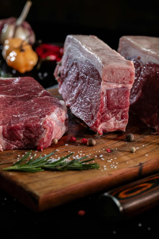 raw meats being prepared on a  board