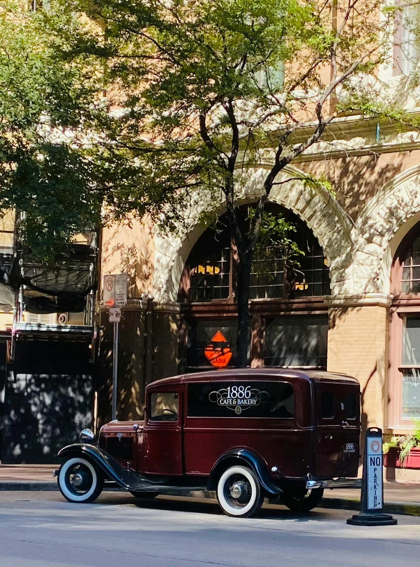 an old car parked in front of a building