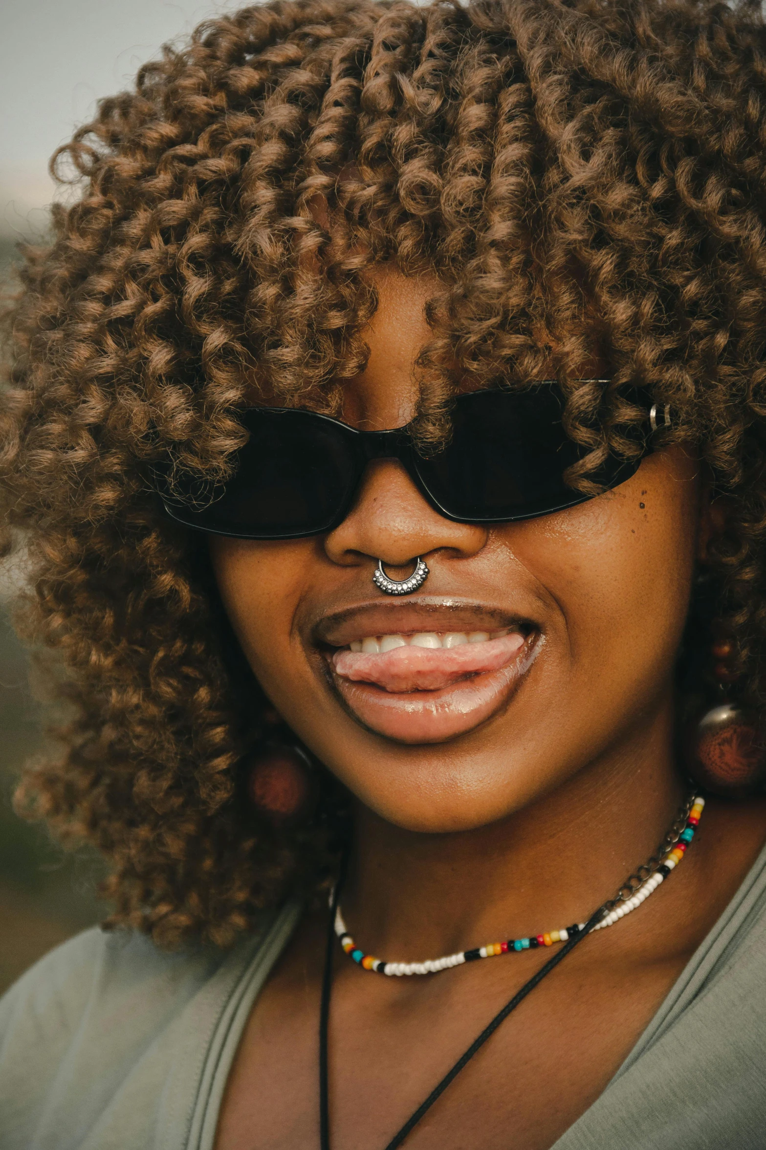 smiling woman with glasses and afro hair