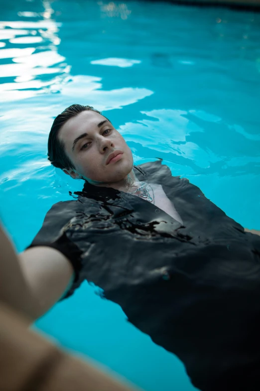 a man in a black shirt that is floating under water