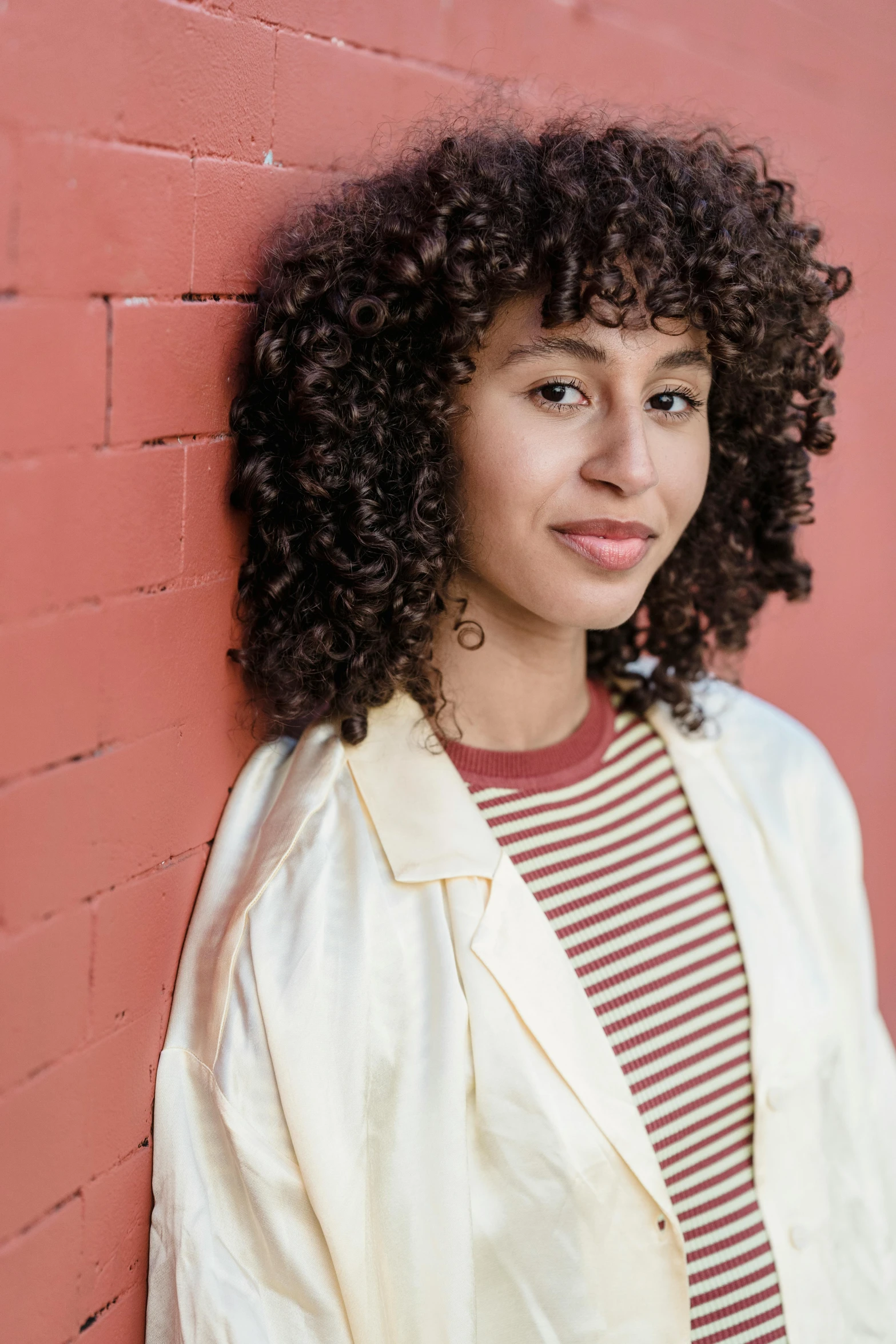 the woman is smiling with her head close to the wall