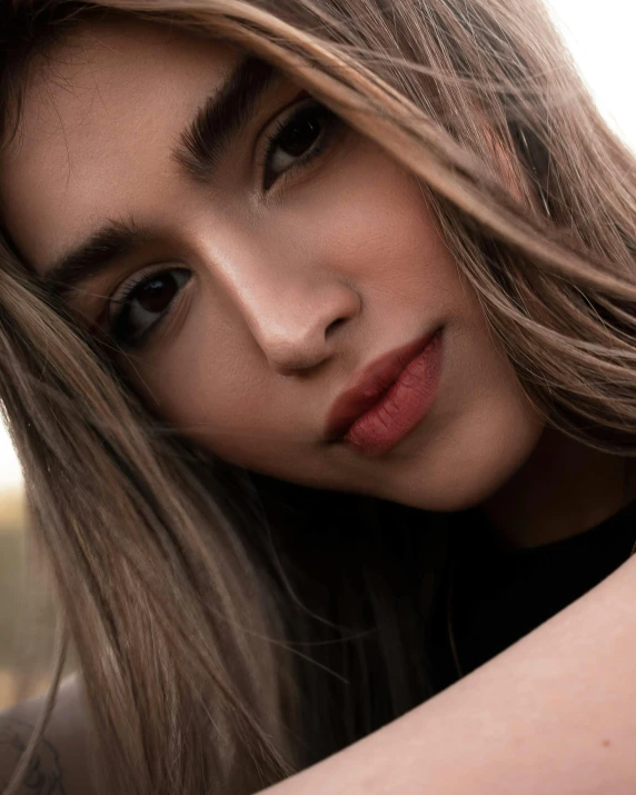 a close up of a woman with her hair flying