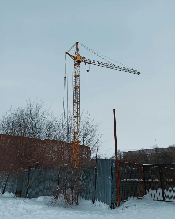 a tower crane outside in the snow