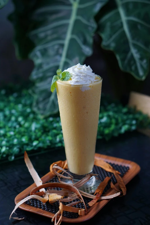 a drink with whipped cream on top and garnish