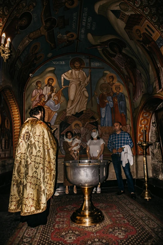 a small chapel with a cross and a painting on the wall