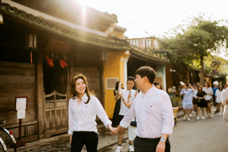 an asian couple holding hands in the street