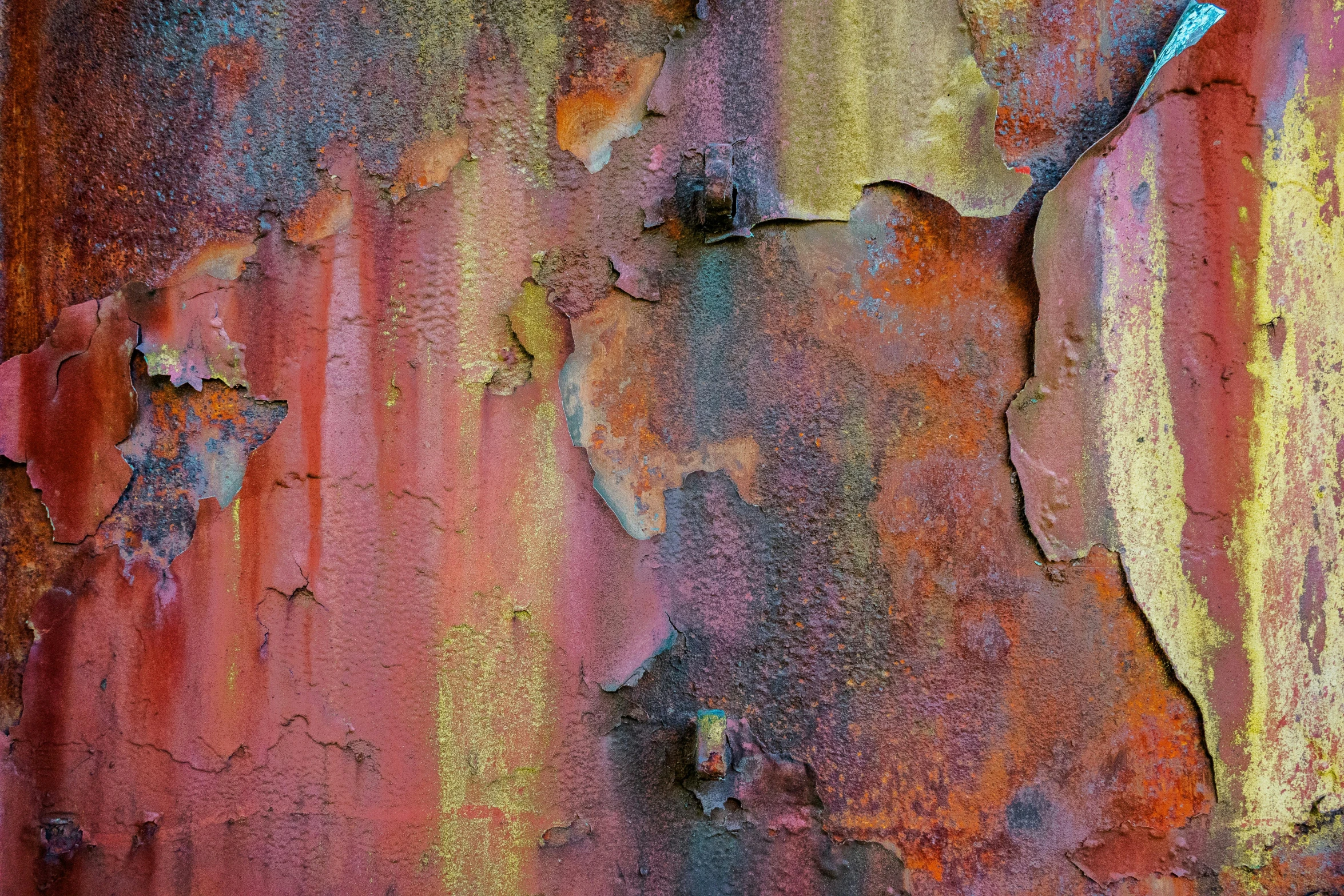 a colorful wall with rust and chipped paint
