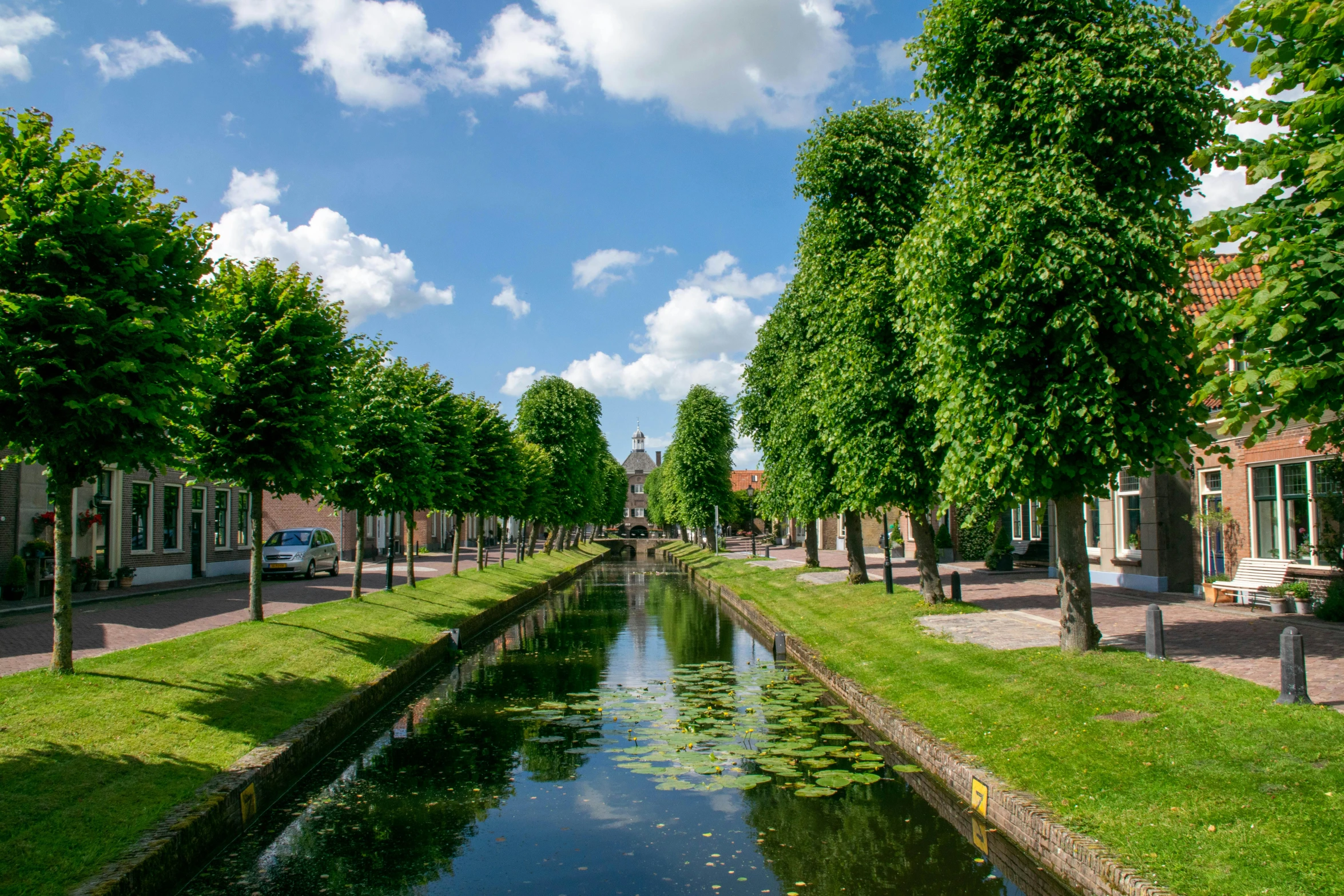 a wide canal surrounded by houses on the other side of it