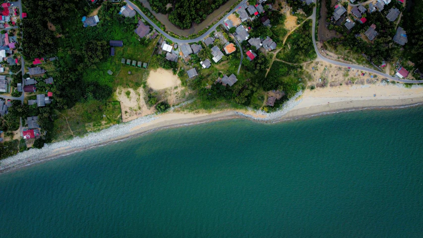 an aerial view of a village on the shore