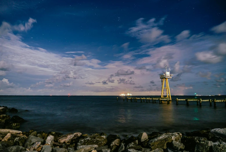 a light house is shown on the water