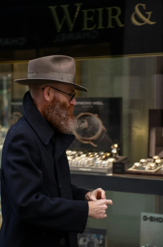 man walking past a store with many watches on display