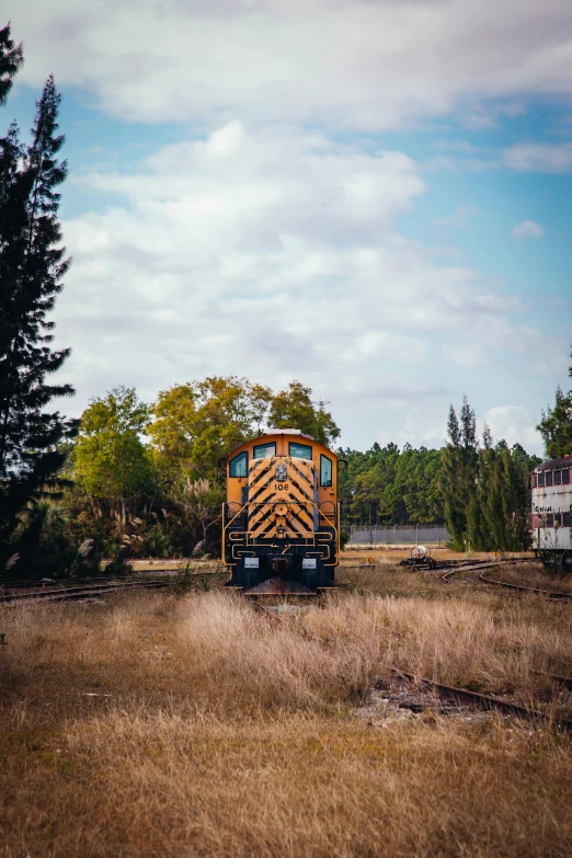 this is a picture of a yellow train on some tracks