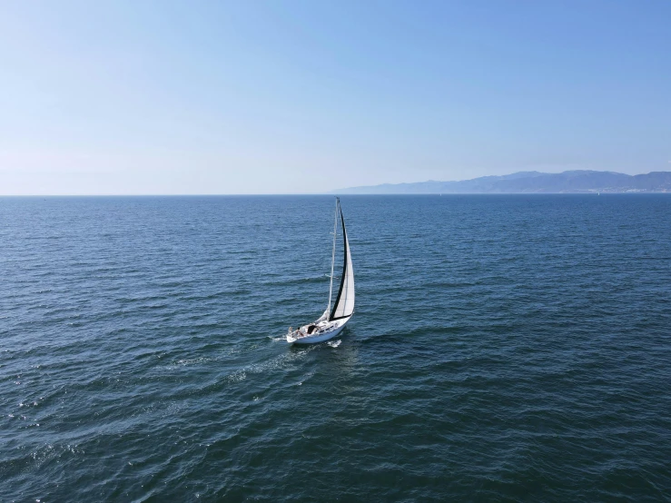 a sailboat sailing on the open blue water