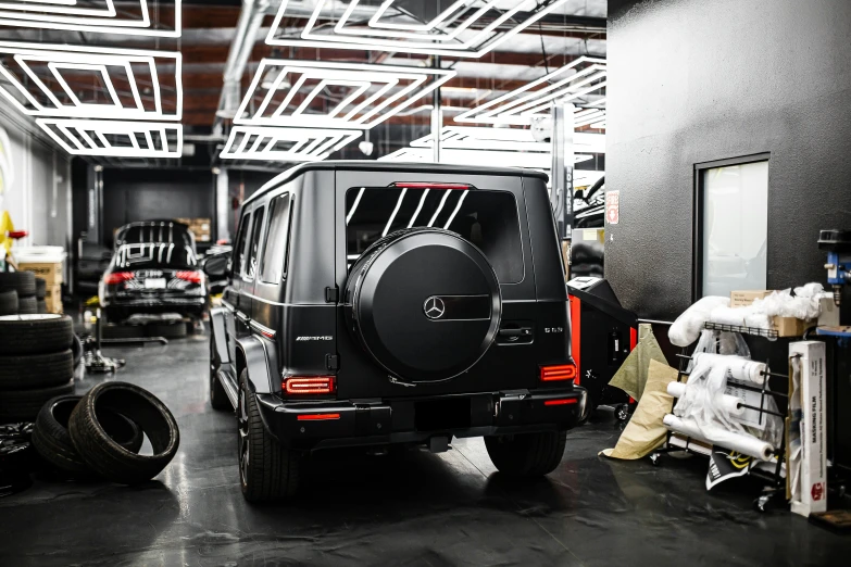 a jeep parked in a building with lots of tires