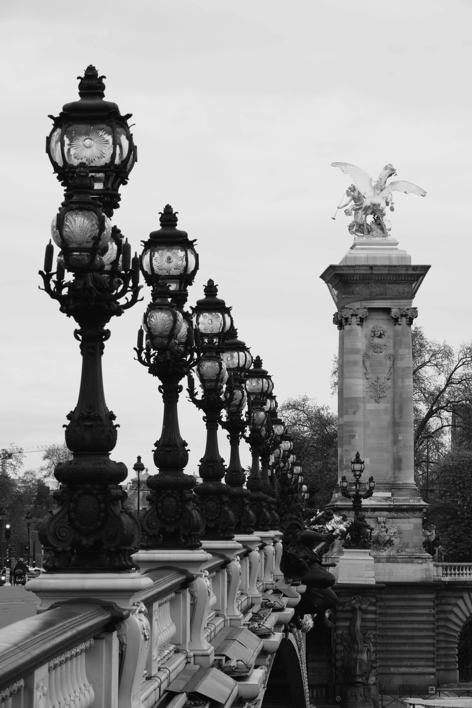 a long s of an outside area with lamps and statues