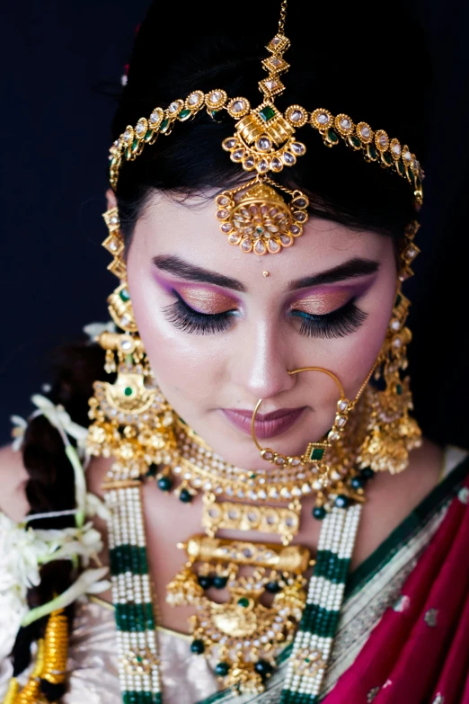 a woman wearing an elaborate headpiece with a nose piece