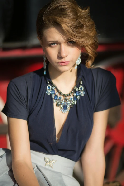 the young lady is wearing blue and silver jewelry