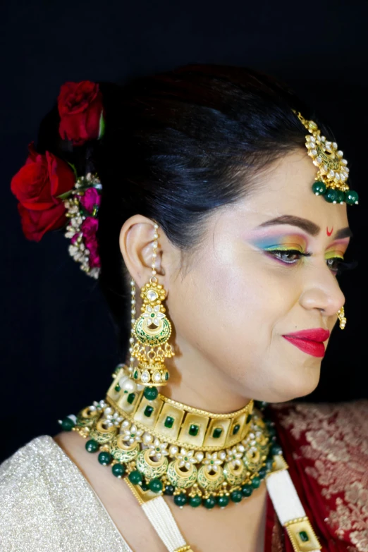 the model in a traditional indian bridal outfit with roses