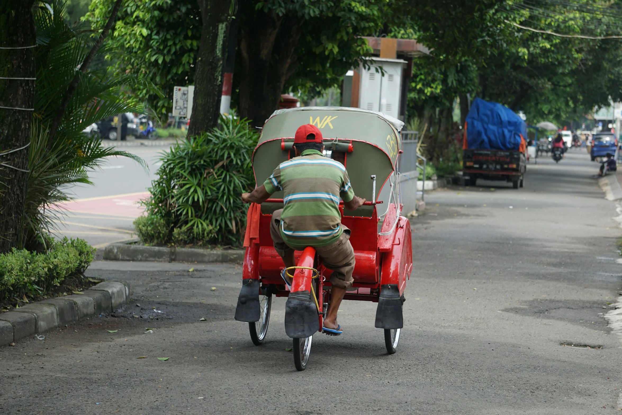 a man and child riding on the back of a small carriage