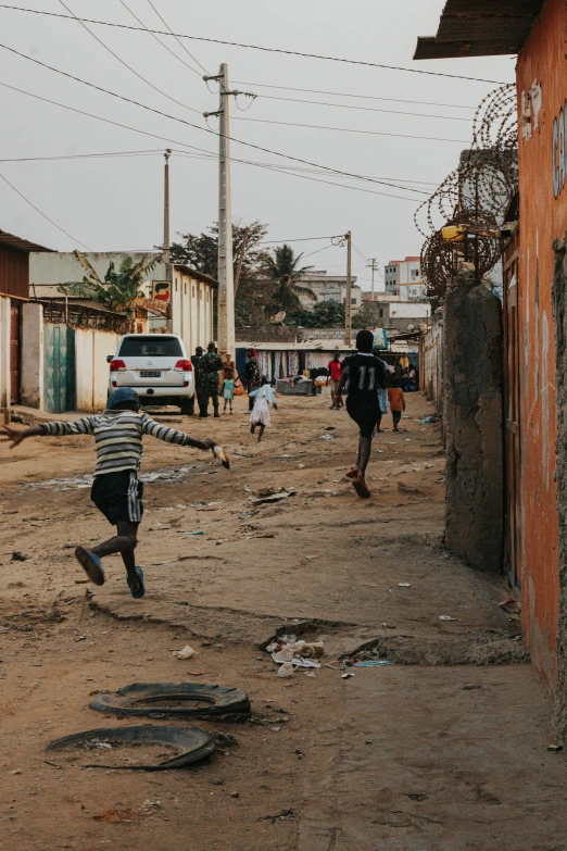 people in a small town by some old houses