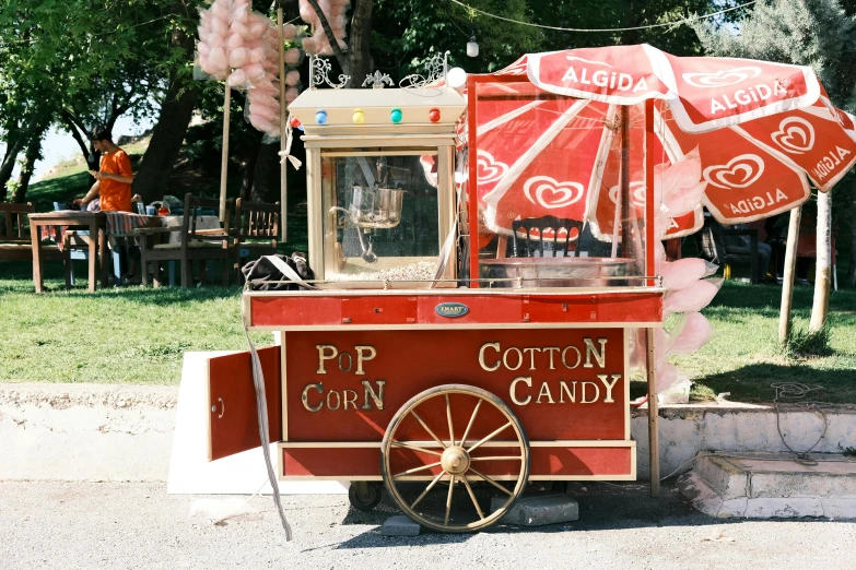 a red wagon with umbrellas for food stands