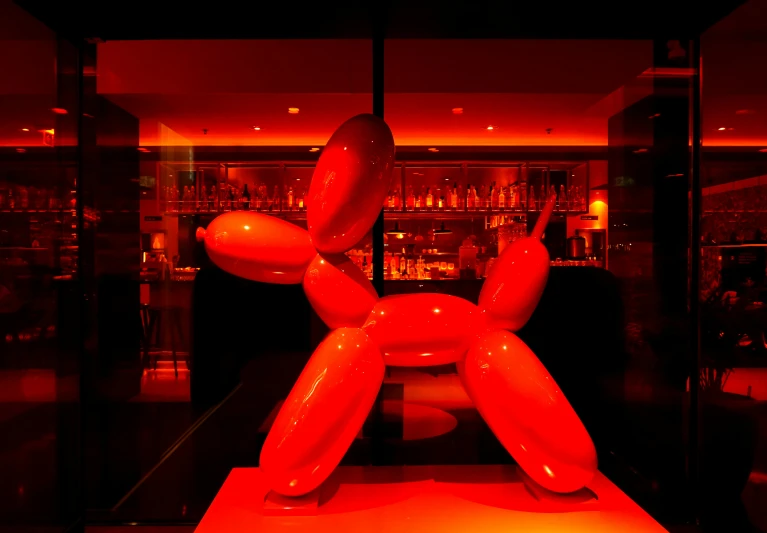 a balloon dog is displayed inside a black and red building