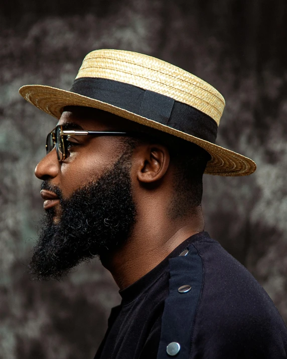 a man with a hat, glasses and sunglasses is shown