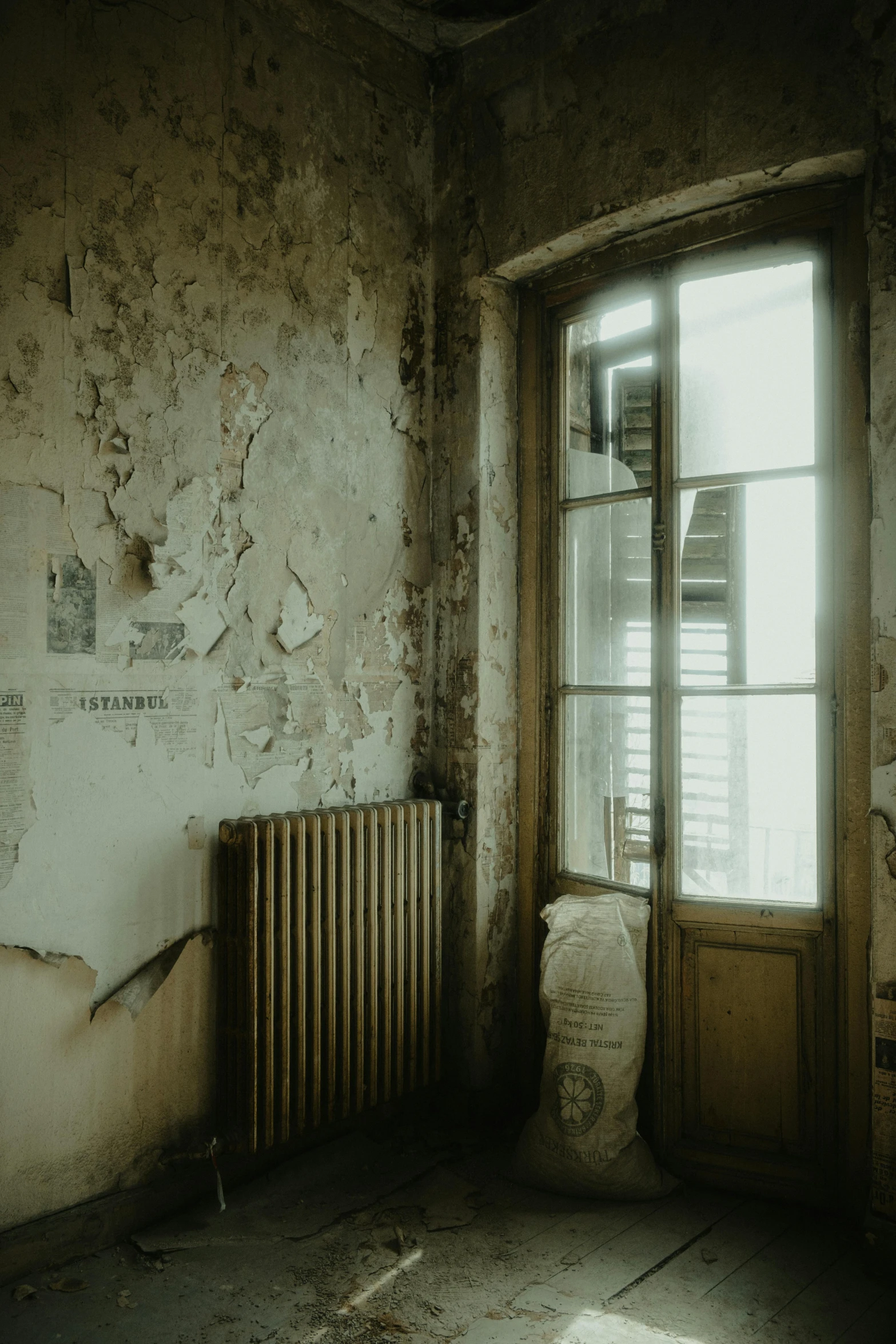 an old run down room with wood furniture and windows