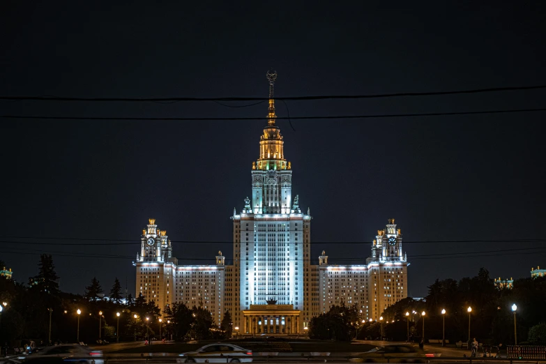 an ornate building sits against a dark sky at night